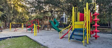 A playground with various play structures including slides and climbing frames.