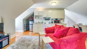 A compact living space with a kitchenette, a red sofa, and a small table. - 4 Mi to Dtwn: Simplistic Summerville Studio (Summerville)