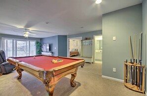 A pool table in a room with a ceiling fan, a television, and a door leading to another room. - Lake-view Patio, Pool Table! Camdenton Family Unit (Camdenton)