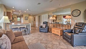 A spacious living room with a sofa, a recliner, and a bar area. - Branson Resort Condo w/ Scenic Patio & Pool Access (Branson)