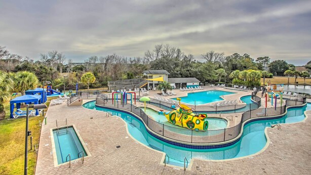 A multi-level swimming pool complex with various pool shapes and a slide. - Summerhouse Villas Condo: Private Resort Beach! (Pawleys Island)