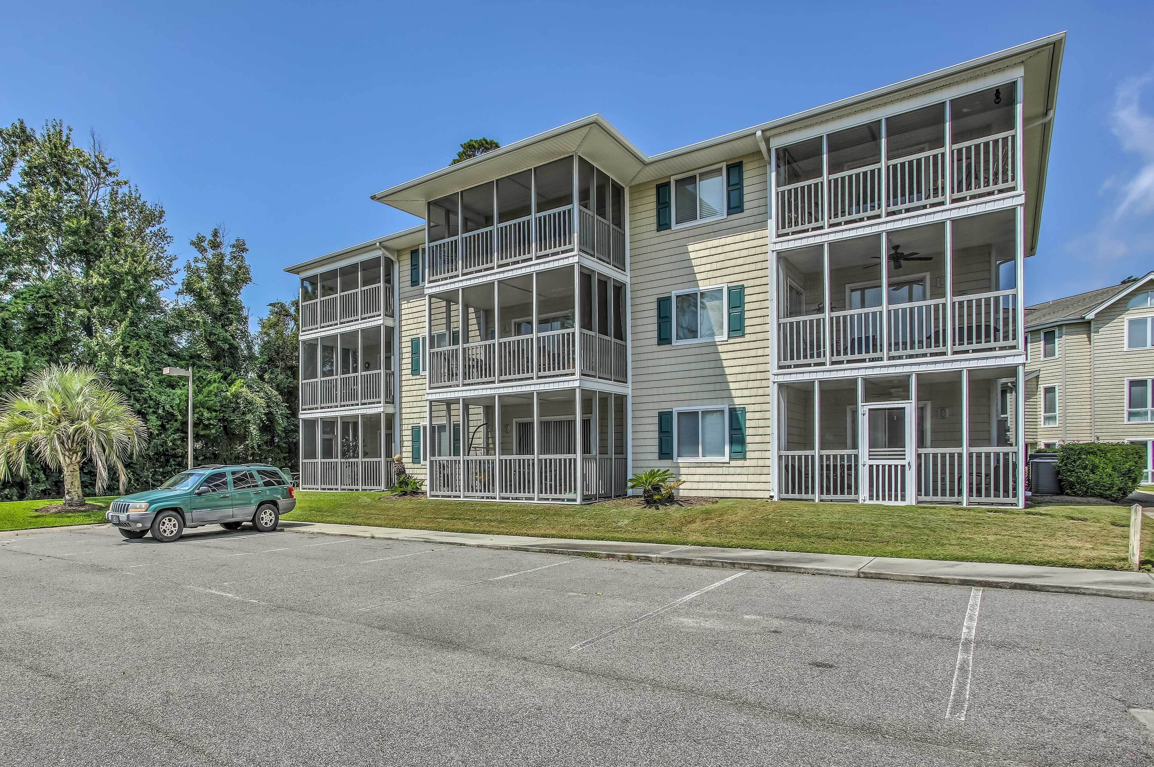 A multi-story apartment building with balconies and large windows.