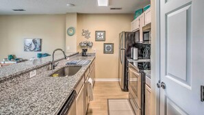 A kitchen with granite countertops, stainless steel appliances, and light wood cabinets. - Sunny N Myrtle Condo w/ Pool < 2 Mi to Beach! (North Myrtle Beach)