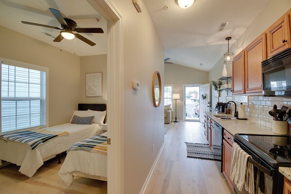 A bedroom with two beds, a ceiling fan, and a window with blinds. - Walk to Ocean: Myrtle Beach Home w/ Pool Access (Myrtle Beach)