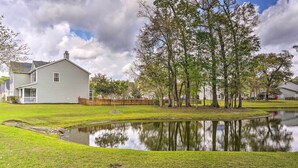 A house with a pond in front, surrounded by trees and a wooden fence. - Summerville Family Home ~ 20 Mi to Charleston (Summerville)