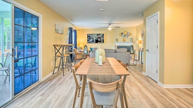A dining area with a wooden table and chairs, a chandelier, and a sofa in the background. - Summerville Family Home ~ 20 Mi to Charleston (Summerville)