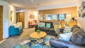A modern living room with a sofa set, a coffee table, and a decorative lamp.