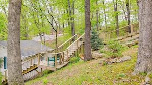 A wooden staircase leading to a cabin in a forested area. - Waterfront Ozarks Home w/ Hot Tub, Bar & Dock (Rocky Mount)