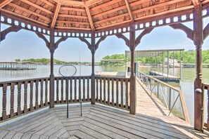 A wooden gazebo with a view of a lake and dock. - Dock! Waterfront Family Home on Lake of the Ozarks (Lake Ozark)