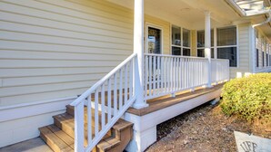A house with a covered porch, wooden steps, and a white railing. - Lakefront Mccormick Gem: Deck & Golf Course Views (McCormick)