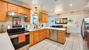 A modern kitchen with wooden cabinets, stainless steel appliances, and a central island. - Yuma Vacation Rental w/ Private Pool & Patio! (Yuma)