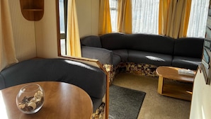 A cozy living area with a sofa, a small table, and a decorative bowl. - 2 Bedroom Caravan Hunstanton Pets go Free (Hunstanton)