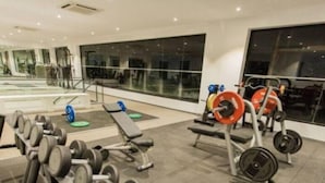 A gym with various weightlifting equipment, including dumbbells and barbells. - Cozy Studio Apartment in heart of Cantonment (Accra)
