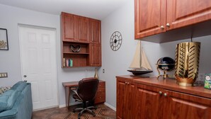 A room with a desk, chair, wardrobe, and a clock on the wall. - Little Cottage on the Field (Buckingham)
