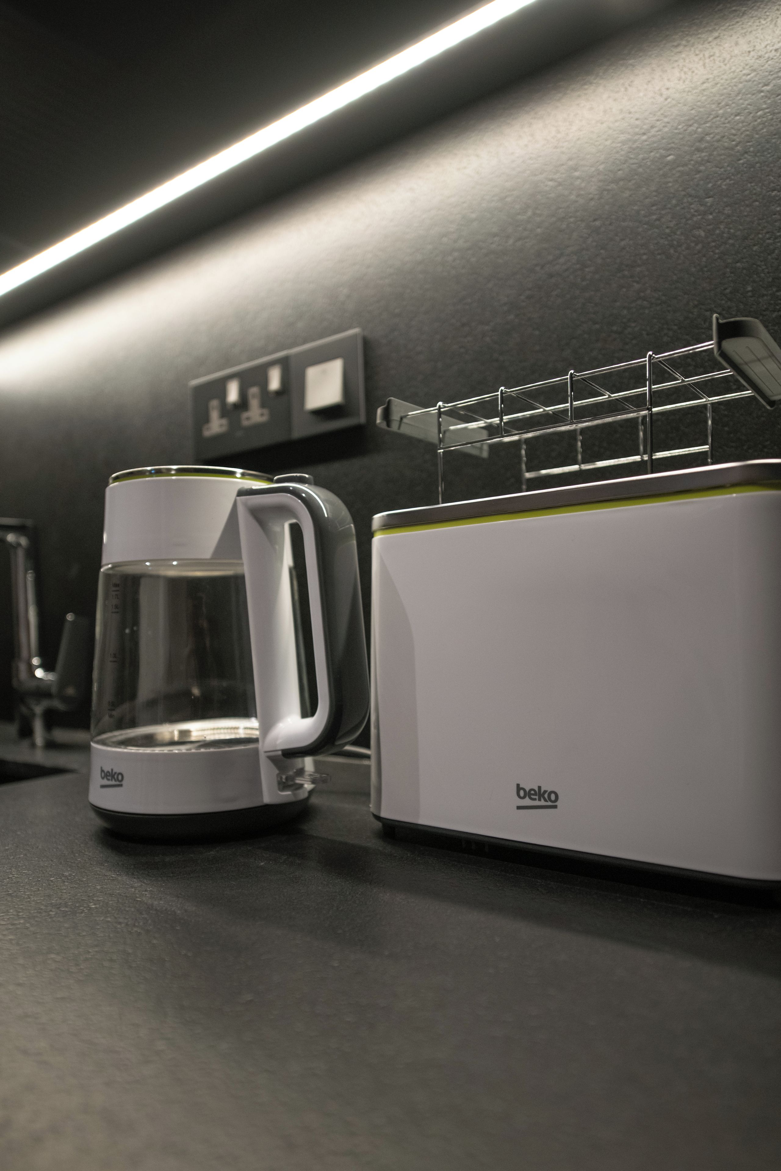 A kitchenette with a coffee maker and a toaster.