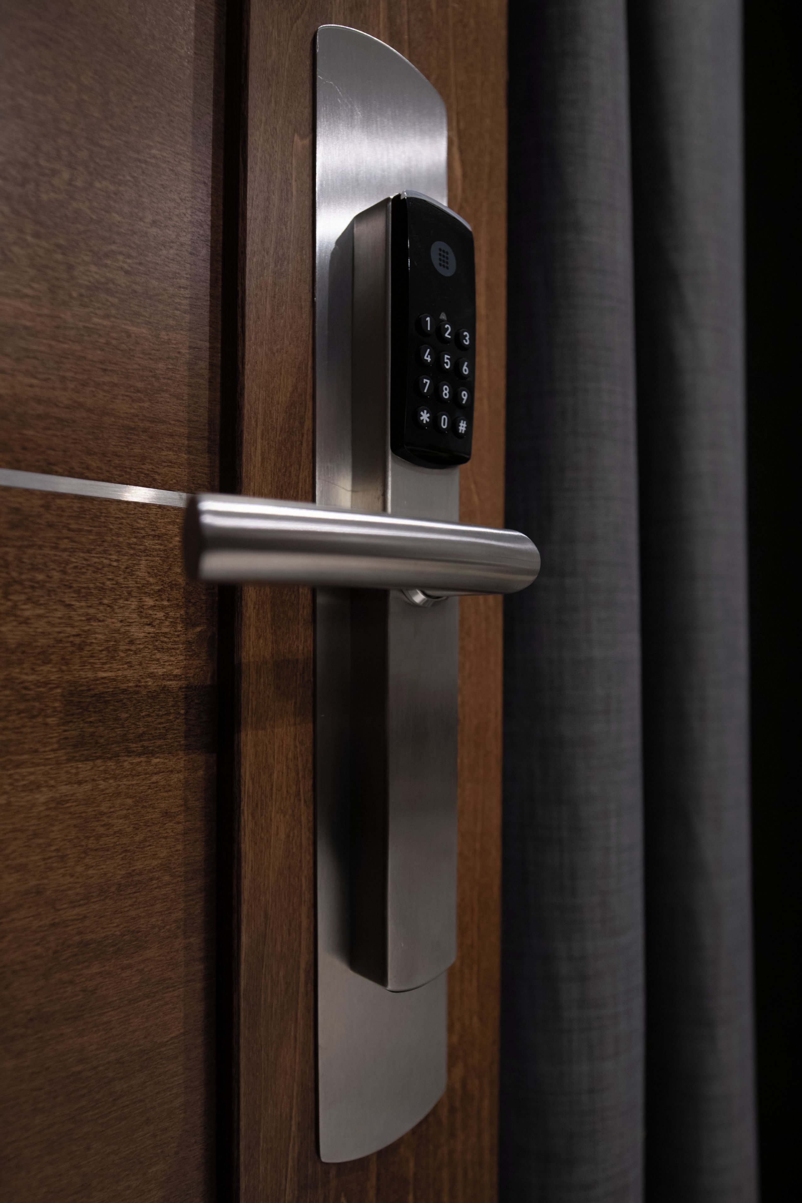 A modern door with a keyless entry system and a metallic handle.