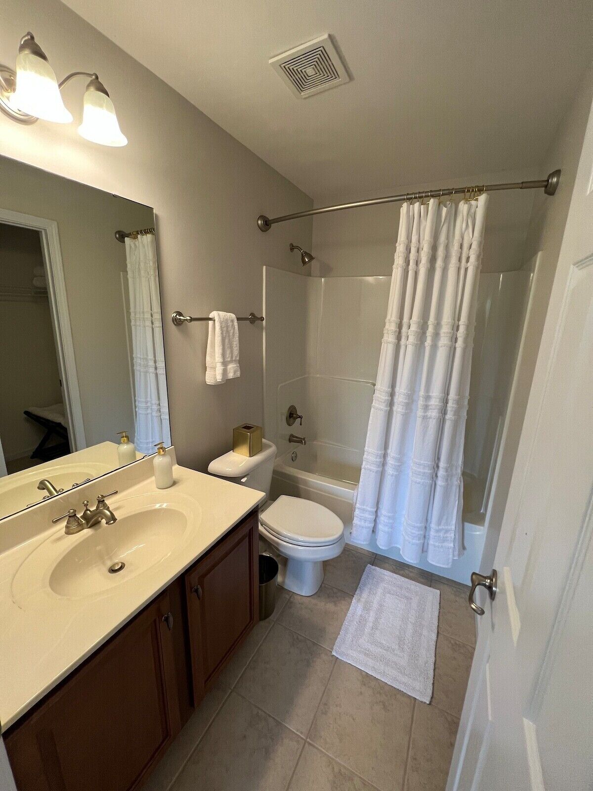 A bathroom with a sink, toilet, and shower.
