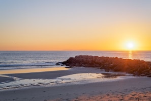 Enjoy a serene beach experience with gentle waves lapping at the shore.