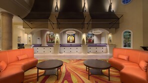 Guests can check in at the Front Desk and enjoy seating areas with sofas and tables.