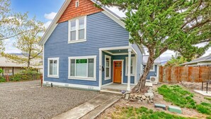 A two-story house with a blue exterior, a red roof, and a front porch. - The Mountain Ave House by WanderLodges (Ashland)
