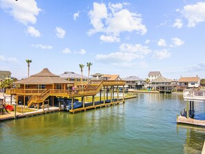 Waterfront property with a pier and deck area, offering stunning views of the marina and surrounding waters.