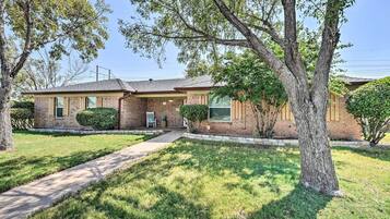 Stroll up to this charming home, surrounded by a lush lawn and mature trees.