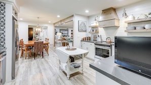 A modern kitchen with a dining area, wooden flooring, and built-in appliances. - 3 Mi to Golf & Wineries: Arroyo Grande Home! (Arroyo Grande)