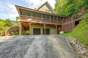 A two-story house with a covered front porch, a wooden staircase, and a garage.