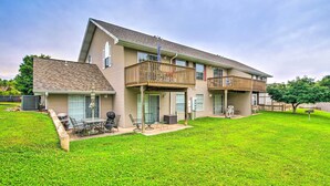 A two-story house with a covered patio, a fenced yard, and a large lawn. - Branson Escape: 9 Mi to Silver Dollar City! (Branson)