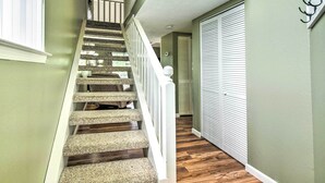 A staircase with carpeted steps and white railings leading to a second floor. - Branson Escape: 9 Mi to Silver Dollar City! (Branson)