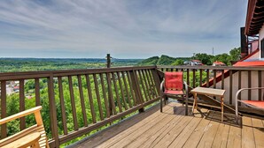 A wooden deck with a railing, a table, and two chairs. - Burkesville Apt w/ Deck, Views & Pool Access! (Burkesville)