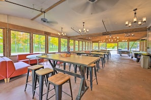 A spacious dining area with high ceilings, large windows, and multiple tables and chairs. - Cassopolis Cabin w/ Lake & Fishing Access! (Cassopolis)