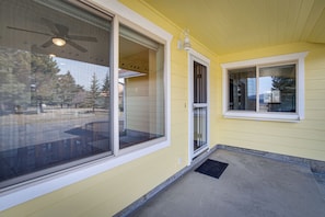 A yellow building with large windows and a ceiling fan.