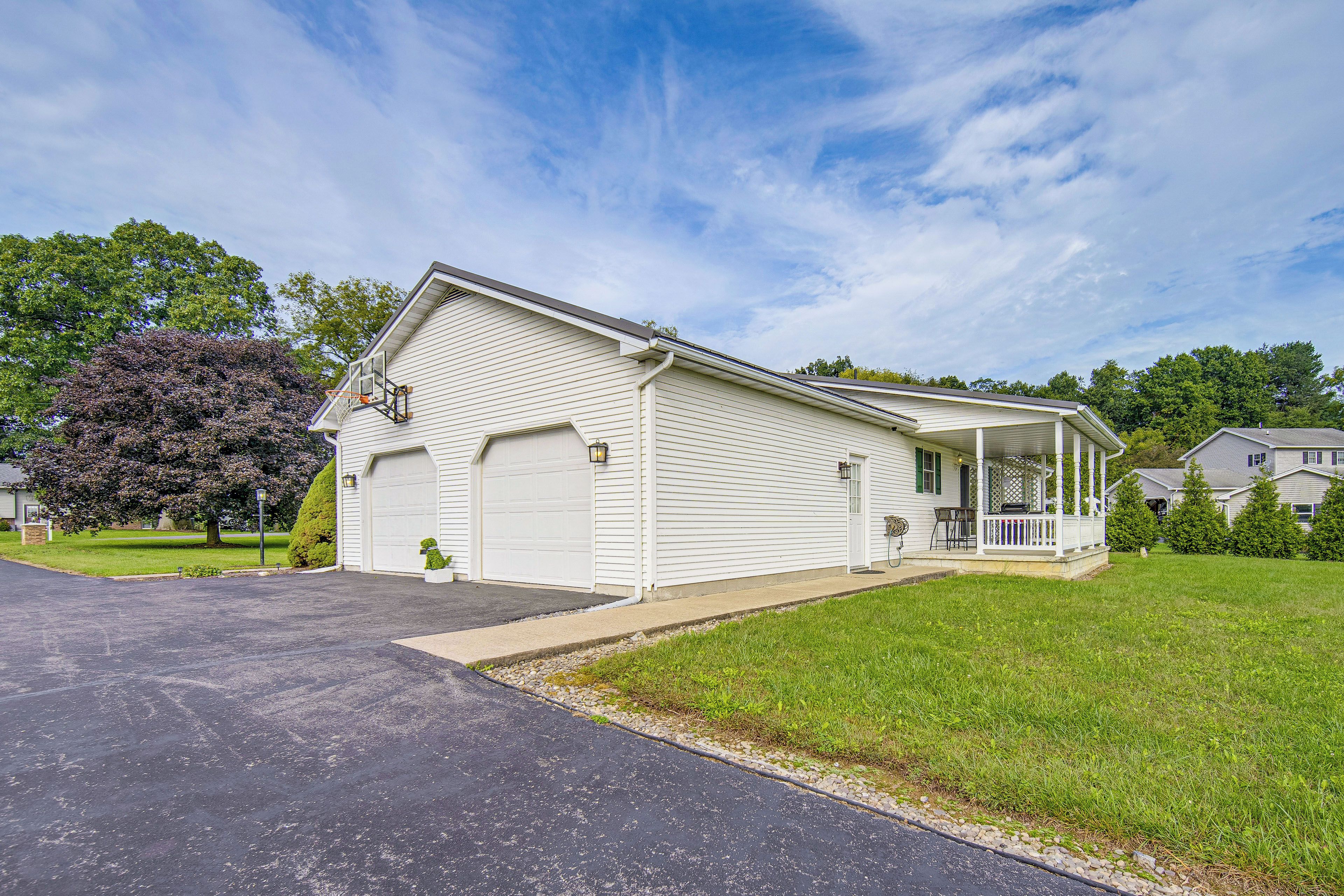 A single-story house with a garage, a covered porch, and a well-maintained lawn.