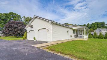 A single-story house with a garage, a covered porch, and a well-maintained lawn.