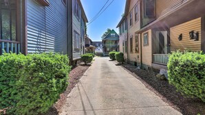 A residential street with houses on both sides, a clear sky, and a sidewalk. - < 3 Mi to Dtwn: Cleveland Apt w/ Deck & Wet Bar (Cleveland)