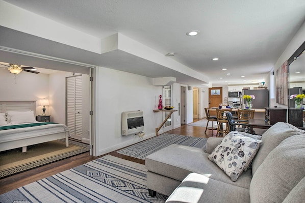 A modern living room with a sofa, a bed, and a dining area. - 4 Mi to Coors Field: Charming Apartment w/ Patio (Denver)