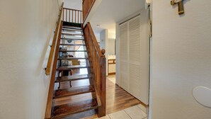 A wooden staircase with a wooden railing leading to a landing.