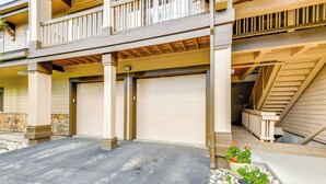 A two-story building with a covered garage and a balcony. - Condo w/ Mtn View < 1 Mi to Steamboat Resort! (Steamboat Springs)