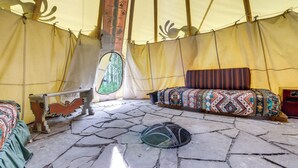 A tent with a bed, a bench, and a window. - Colorful Cabin w/ Teepee, Fire Pits & Mtn Views! (Carbondale)