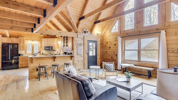 A spacious log cabin interior with a kitchen, dining area, and living room. - 1 Mi to Slopes! Family-friendly Massanutten Cabin (McGaheysville)