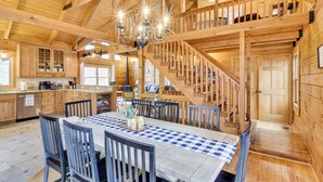 A spacious wooden cabin with a dining area, kitchen, and a staircase leading to an upper level. - 1 Mi to Slopes! Family-friendly Massanutten Cabin (McGaheysville)