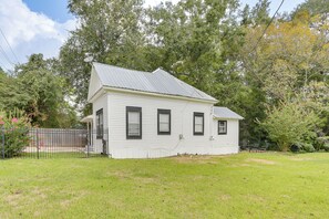 A two-story house with a gabled roof, a front porch, and a fenced yard. - Cozy Livingston House w/ Fenced Yard + Patio! (Livingston)