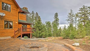 A wooden cabin with a stone fire pit and a deck. - Expansive Hartsel Home w/ Mtn Views Near Hiking (Hartsel)