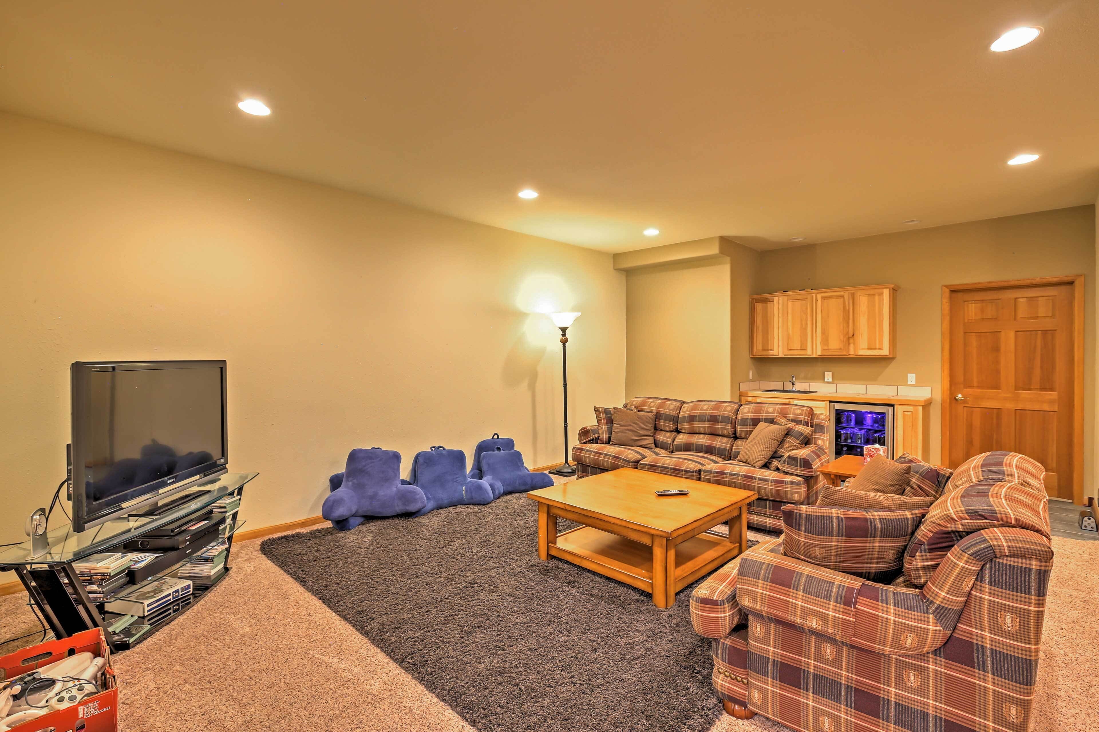 A living room with a flat-screen TV, a coffee table, a sofa, and a fireplace.