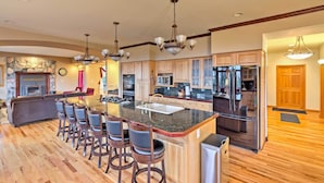 A spacious kitchen with a central island, bar stools, and modern appliances. - Expansive Hartsel Home w/ Mtn Views Near Hiking (Hartsel)