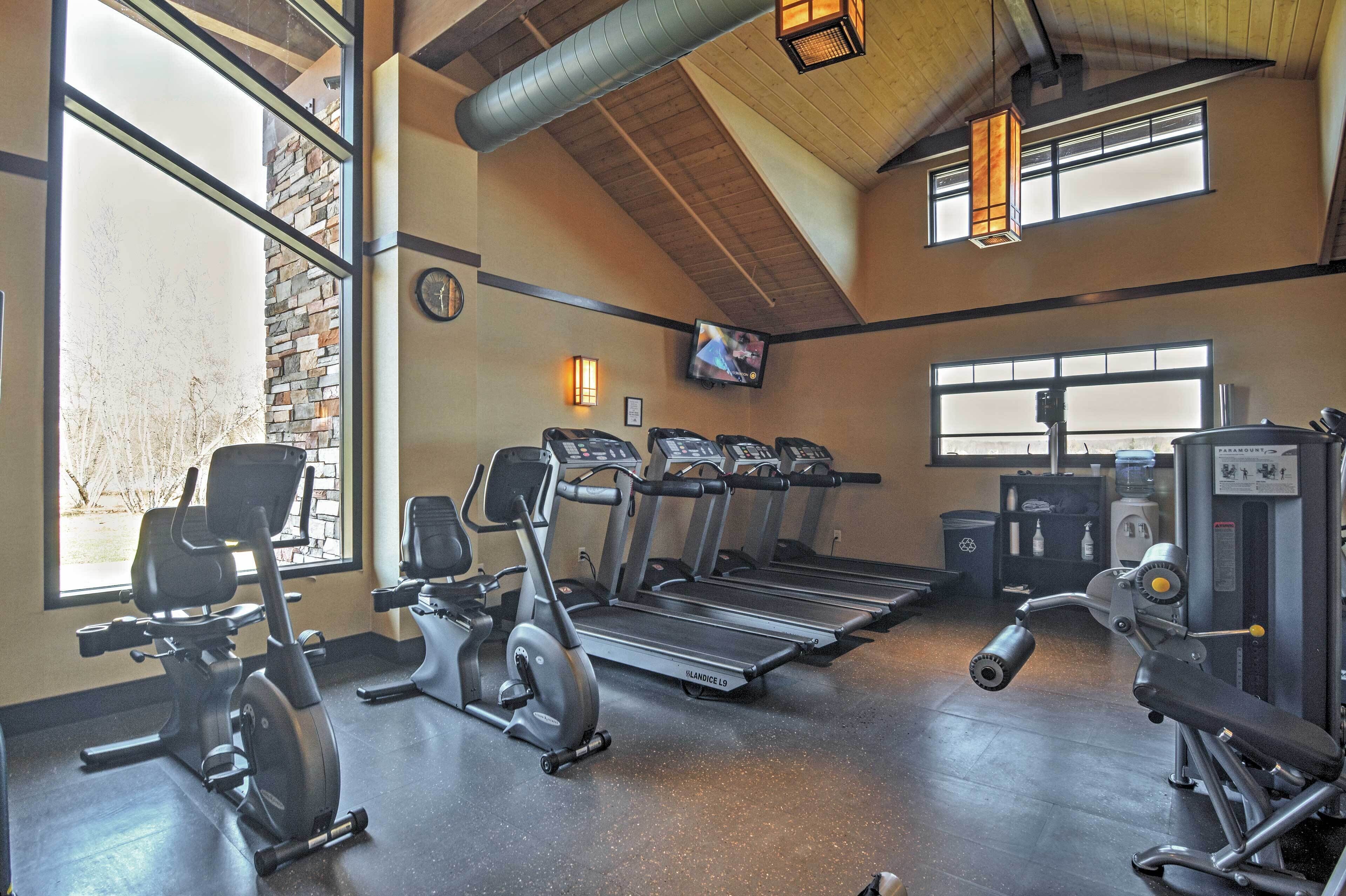 A gym with treadmills, elliptical machines, and weight equipment.