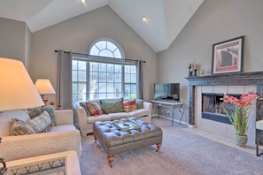 A living room with a high ceiling, a fireplace, a television, and a large window. - < 1 Mi to Marina: Family-friendly Osage Beach Home (Osage Beach)