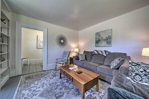 A living room with a sofa, armchairs, a coffee table, and a bookshelf. - Near Lakes, Bay & Trails! Historic Waldoboro Gem (Waldoboro)