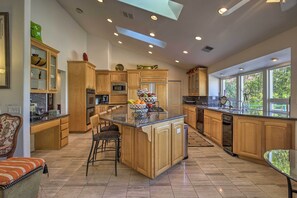 Enjoy cooking in this well-equipped kitchen with a central island, microwave, oven, and dishwasher.